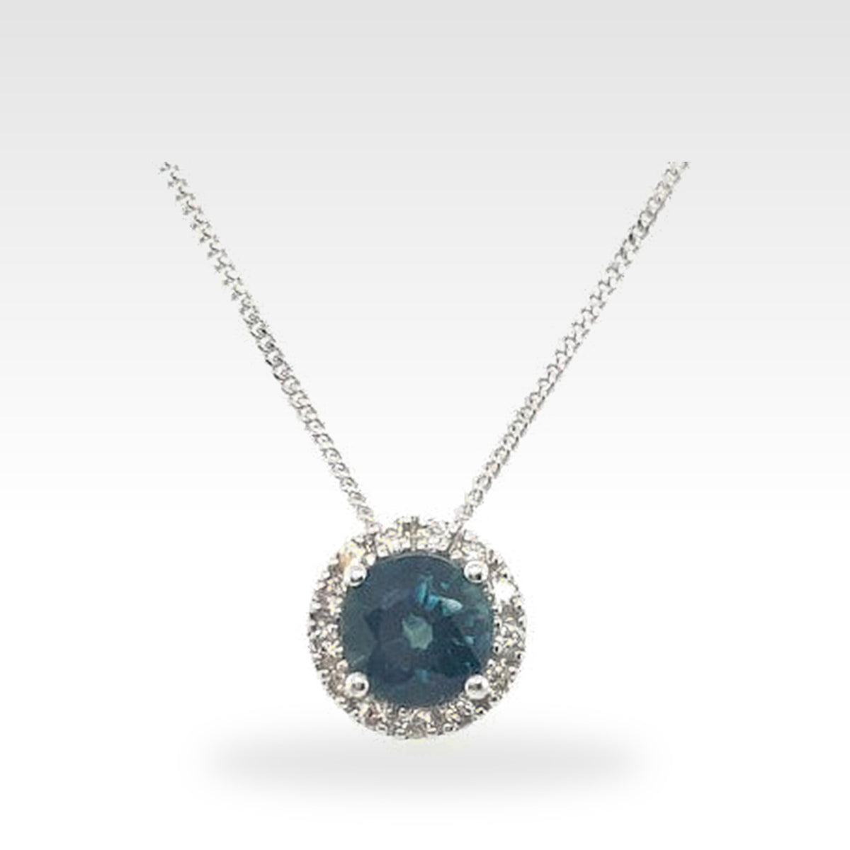 18ct Sapphire Halo Pendant in 18ct white gold with round diamonds