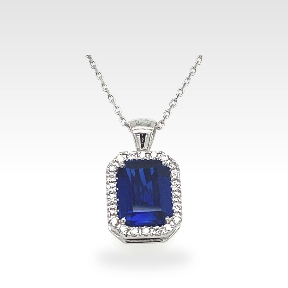 Blue Gemstone & Diamond Halo Pendant in 18ct white gold